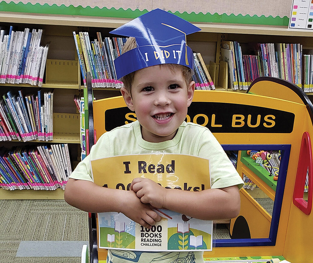 Kristina and Matthew Bailey began reading books to their son, Owen when he was six months old— they haven’t stopped.
Owen turned 4 in June and recently received an award from the Clarendon Hills Public Library for having had 1,000 books read to him before starting kindergarten.

The library’s 1,000 Books Before Kindergarten Challenge is one of a few reading challenge programs offered in Clarendon Hills, where the Bailey family has lived for the past 2 1/2 years.
Kristin Bailey said she saw an ad about the 1,000 Books Before Kindergarten Challenge and decided it was a good fit for Owen.

“He’s always been really into books,” Bailey said. “He had a natural interest in books at nine months old. That’s when COVID started, and he didn’t get out much, so reading books to him worked out very well. He’s a naturally curious kid, and imagination-building is important. The reading allows him to learn and explore new things, and he really wants to learn to read now.”

Krista Devlin, the Clarendon Hills library’s youth services librarian, said there’s a specific reason The Friends of the Library-sponsored 1,000 Books Before Kindergarten Challenge was started in 2022.

“Reading aloud to a child is one of the best ways to help develop important early literacy skills, which will prepare them for kindergarten,” Devlin said. “It is also a great way to bond with your child and to encourage a love of reading.”

Devlin said Owen was the second child to reach the challenge of having 1,000 books read to him before starting kindergarten. He was awarded a certificate, a crown, and his picture was taken to recognize his accomplishment.

Bailey, who said she is “a big reader,” said her family usually goes to the library once a week. Reading three books each night to Owen, along with a book before nap time, is the household normal.

“Consistency in our routine has been good and is important,” she said, adding that Owen’s two sisters, ages 2 1/2 and 1