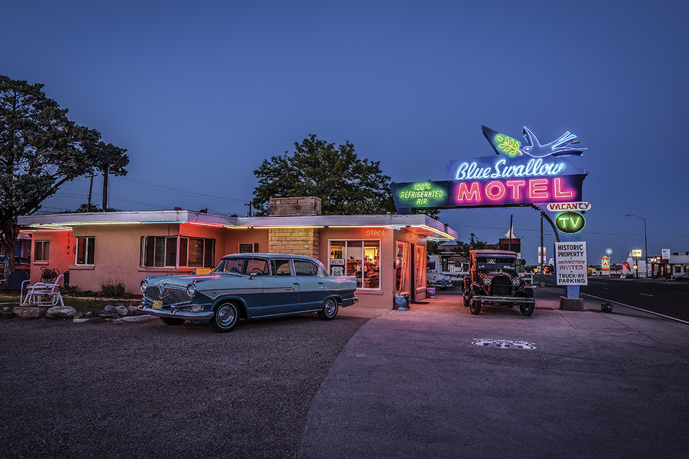 Tucumcari, New Mexico, USA - May 13, 2016 : Historic Blue Swallow Motel with vintage cars parked in front of it. This building is listed on the National Register of Historic Places in New Mexico as a part of historic U.S. Route 66.