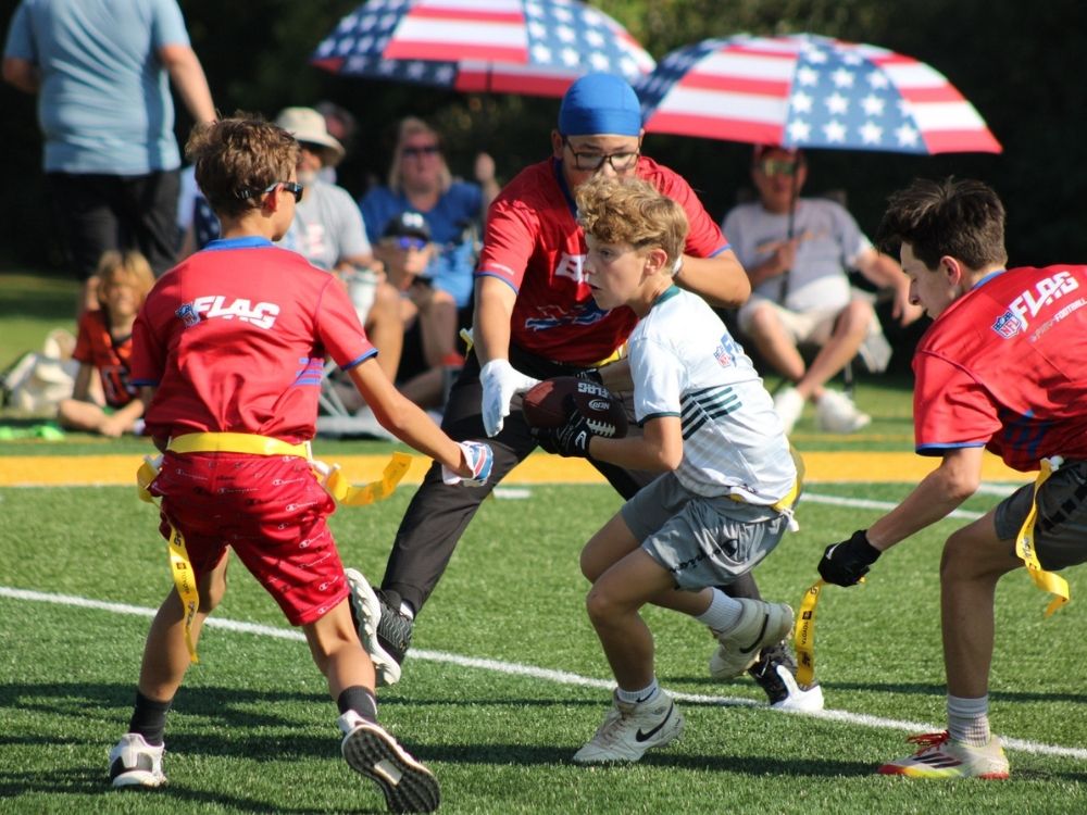 Sunday Funday players run a play in flag football last fall