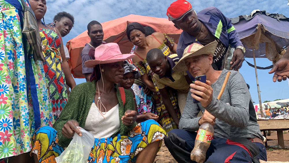 Candid photo of the original creator of the technique used explaining the process and showing on his phone