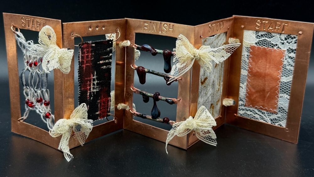 Aili Flannery’s award-winning sculpture, “Process,” was made of copper, string, copper wire, glass beads, glass, rust-stained fabric, lace, turmeric sun-printed paper, and thread. It represents “the timeline of having depression to the process of healing,” Flannery explained, and the theme is rooted in her own experiences. “‘Start’ shows up again at the end [of the piece], because I was ready to start healing and to continue living.”
