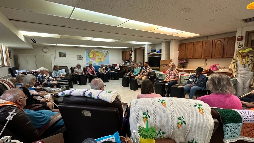 In the Cozy Chair Room, drumming is a favorite activity for CADC Members.