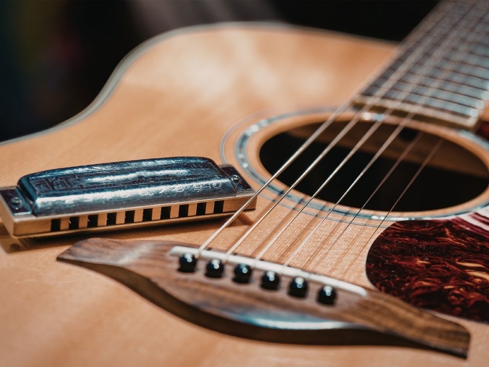 Harmonica sitting on guitar