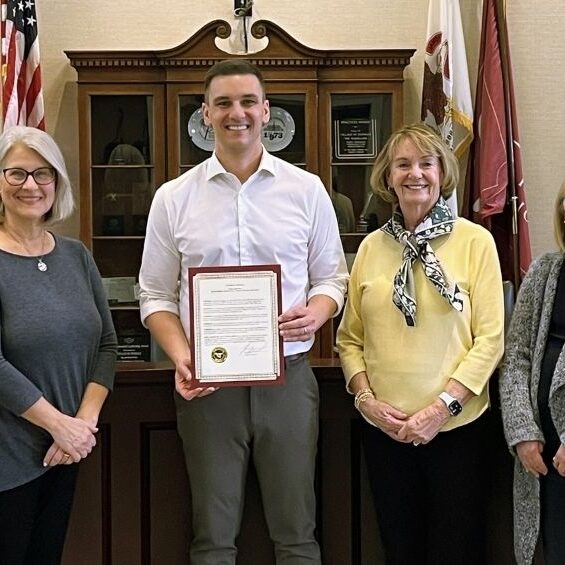 From left to right, Theresa Nevling, Lisa Everette, Village President Greg Hart, Maureen Hegarty, Beth Waldo and Kristina Goel pose with the proclamation for ALCW’s 30 years of service. 
