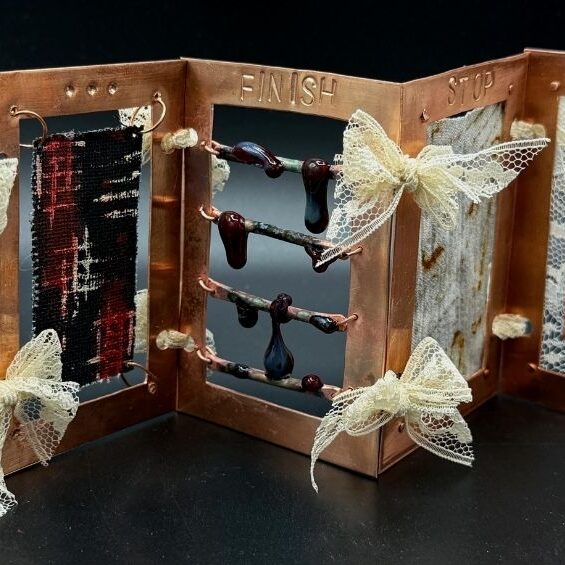 Aili Flannery’s award-winning sculpture, “Process,” was made of copper, string, copper wire, glass beads, glass, rust-stained fabric, lace, turmeric sun-printed paper, and thread. It represents “the timeline of having depression to the process of healing,” Flannery explained, and the theme is rooted in her own experiences. “‘Start’ shows up again at the end [of the piece], because I was ready to start healing and to continue living.”