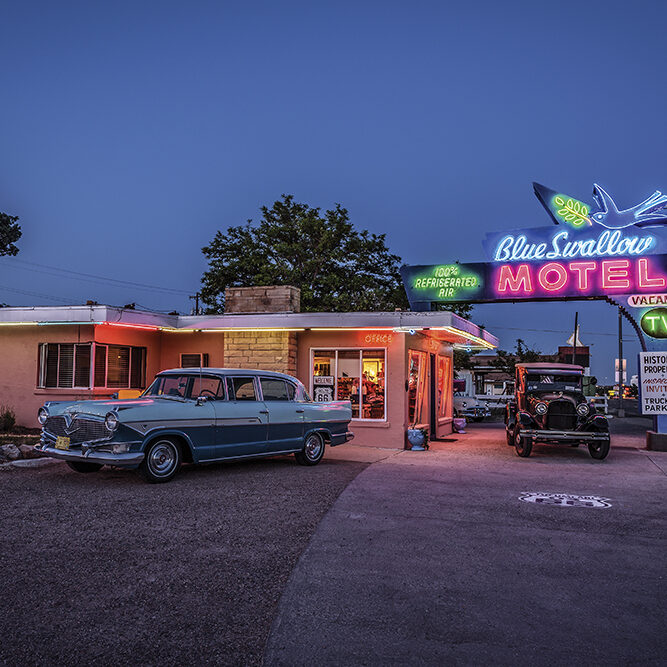 Tucumcari, New Mexico, USA - May 13, 2016 : Historic Blue Swallow Motel with vintage cars parked in front of it. This building is listed on the National Register of Historic Places in New Mexico as a part of historic U.S. Route 66.