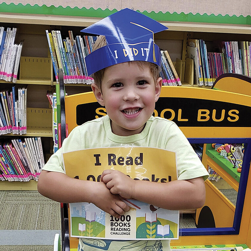 Kristina and Matthew Bailey began reading books to their son, Owen when he was six months old— they haven’t stopped.
Owen turned 4 in June and recently received an award from the Clarendon Hills Public Library for having had 1,000 books read to him before starting kindergarten.

The library’s 1,000 Books Before Kindergarten Challenge is one of a few reading challenge programs offered in Clarendon Hills, where the Bailey family has lived for the past 2 1/2 years.
Kristin Bailey said she saw an ad about the 1,000 Books Before Kindergarten Challenge and decided it was a good fit for Owen.

“He’s always been really into books,” Bailey said. “He had a natural interest in books at nine months old. That’s when COVID started, and he didn’t get out much, so reading books to him worked out very well. He’s a naturally curious kid, and imagination-building is important. The reading allows him to learn and explore new things, and he really wants to learn to read now.”

Krista Devlin, the Clarendon Hills library’s youth services librarian, said there’s a specific reason The Friends of the Library-sponsored 1,000 Books Before Kindergarten Challenge was started in 2022.

“Reading aloud to a child is one of the best ways to help develop important early literacy skills, which will prepare them for kindergarten,” Devlin said. “It is also a great way to bond with your child and to encourage a love of reading.”

Devlin said Owen was the second child to reach the challenge of having 1,000 books read to him before starting kindergarten. He was awarded a certificate, a crown, and his picture was taken to recognize his accomplishment.

Bailey, who said she is “a big reader,” said her family usually goes to the library once a week. Reading three books each night to Owen, along with a book before nap time, is the household normal.

“Consistency in our routine has been good and is important,” she said, adding that Owen’s two sisters, ages 2 1/2 and 1