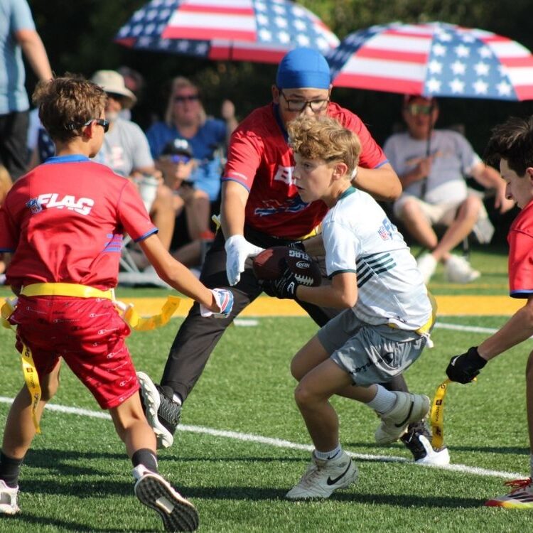 Sunday Funday players run a play in flag football last fall