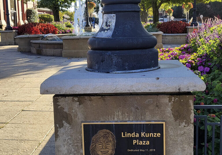 A plaque commemorates Linda Kunze Plaza outside the
 Main Street Train Station.