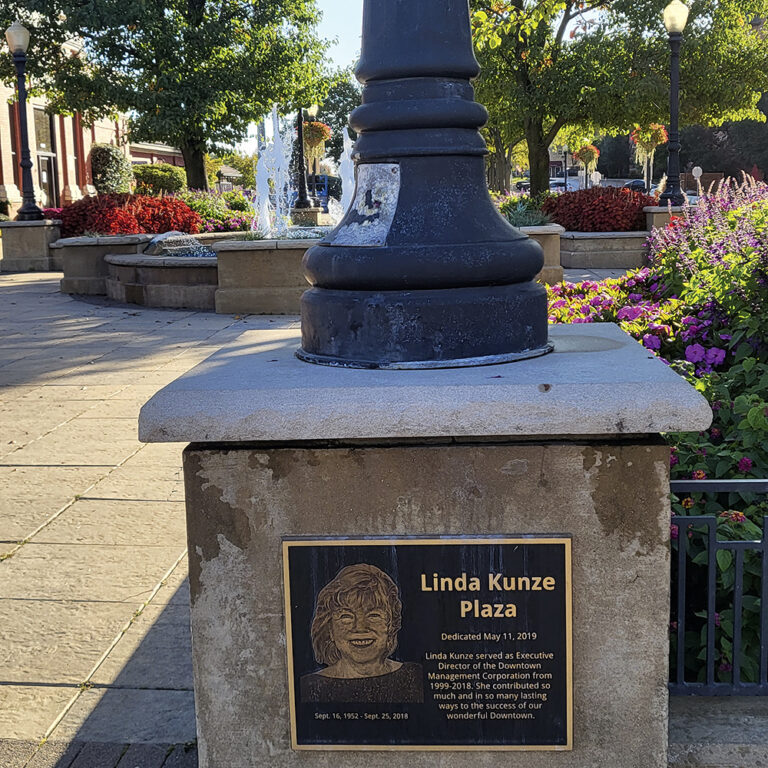 A plaque commemorates Linda Kunze Plaza outside the
 Main Street Train Station.